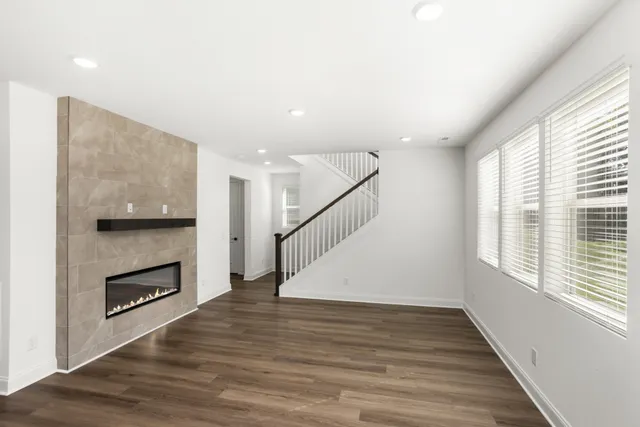 a room with a table chairs and a refrigerator