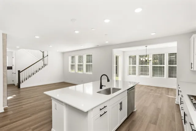 a view of an empty room with glass door and windows