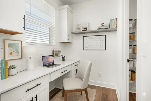 a view of an empty room with a window and chandelier