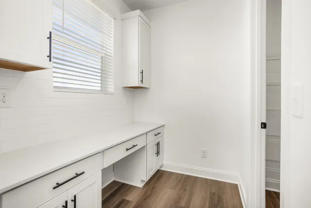 a kitchen with stainless steel appliances kitchen island granite countertop a sink stove and refrigerator