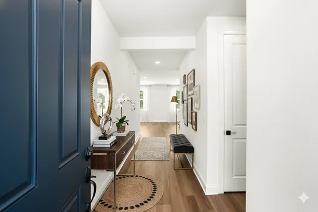 a view of a hallway with furniture and floor to ceiling window