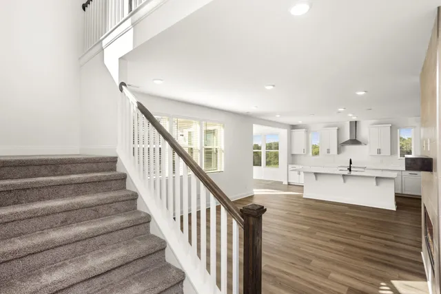 a view of hallway with a window and wooden floor