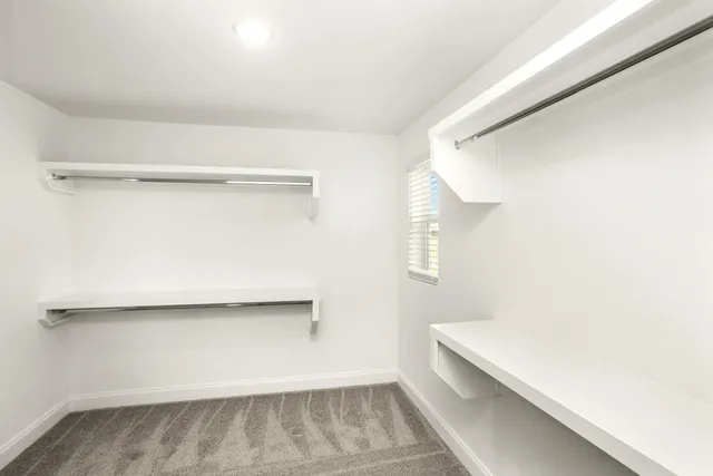 a view of a white house next to a yard