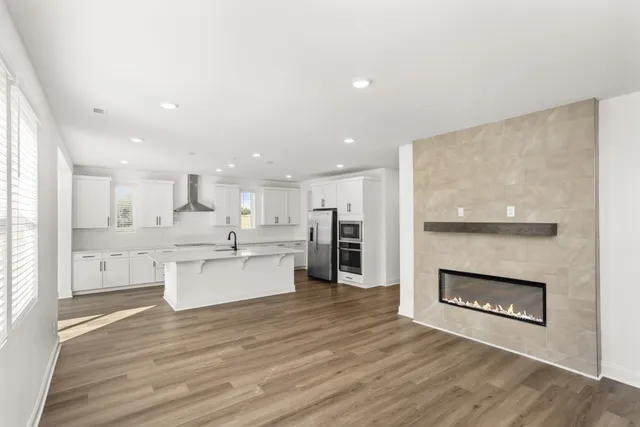 a large kitchen with kitchen island a large counter top space a sink stainless steel appliances and cabinets