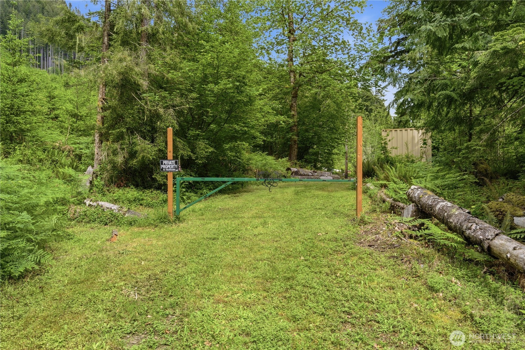 3320 Duckabush Road Brinnon, WA 98320 - Photo 33 of 38 a backyard of a house with lots of plants and tree