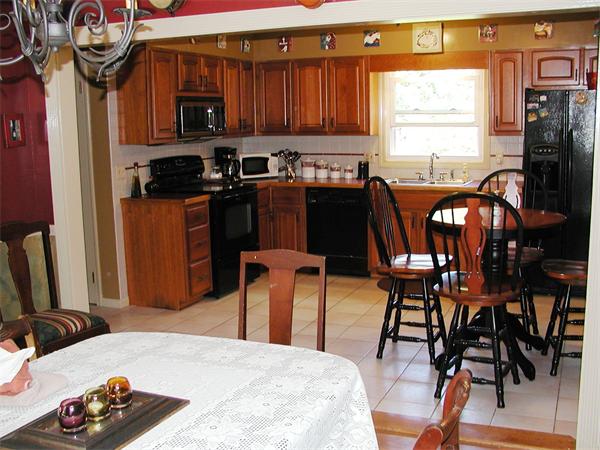 40 Long Plain Road Whately, MA 01373 - Photo 3 of 15 a kitchen with stainless steel appliances kitchen island granite countertop a table chairs in it and a window