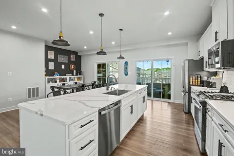 a kitchen with stainless steel appliances kitchen island a large island in the center