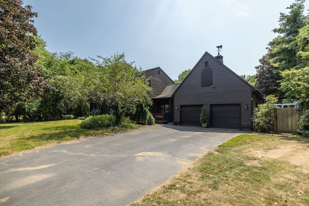 20 Staples Shore Road Lakeville, MA 02347 - Photo 2 of 39 a front view of a house with a yard and garage