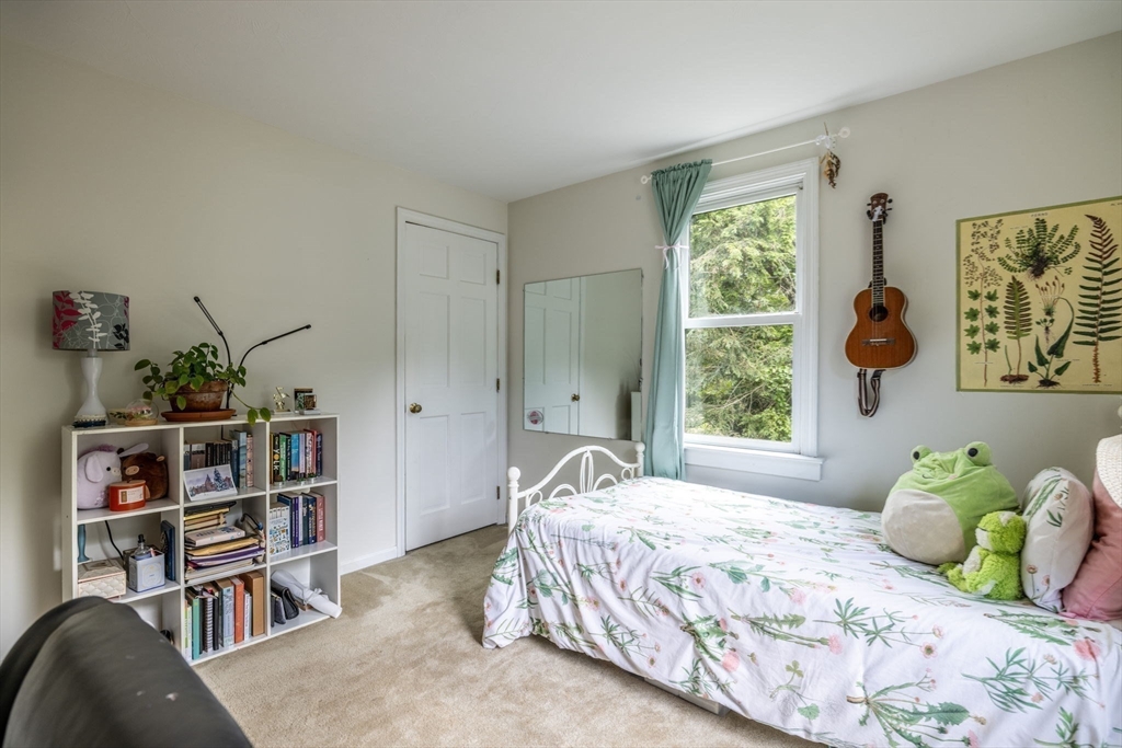 20 Staples Shore Road Lakeville, MA 02347 - Photo 23 of 39 a bedroom with a bed and a book shelf