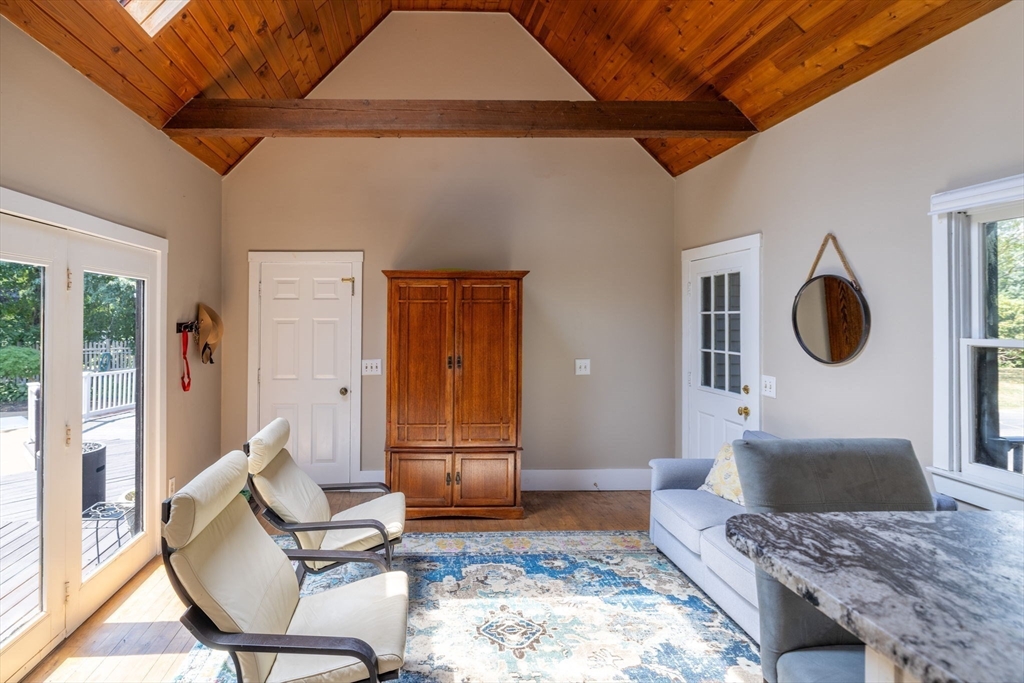 20 Staples Shore Road Lakeville, MA 02347 - Photo 4 of 39 a living room with a couch and a stove next to a window