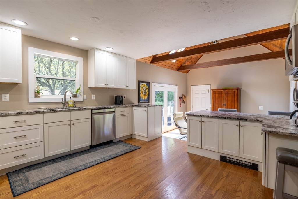20 Staples Shore Road Lakeville, MA 02347 - Photo 7 of 39 a kitchen with granite countertop white cabinets and white appliances