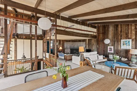 a living room with lots of furniture and a large window