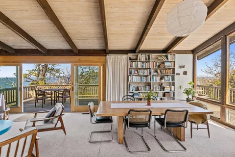 a reading room with furniture and large windows