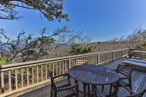 a view of a chairs and table on the deck