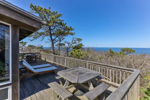 a view of a balcony with mountain view and wooden floor