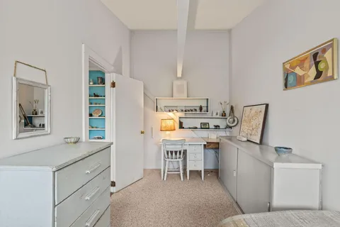 a room with stainless steel appliances furniture a refrigerator and a window