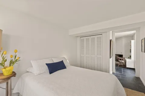 a bedroom with a bed and a couch