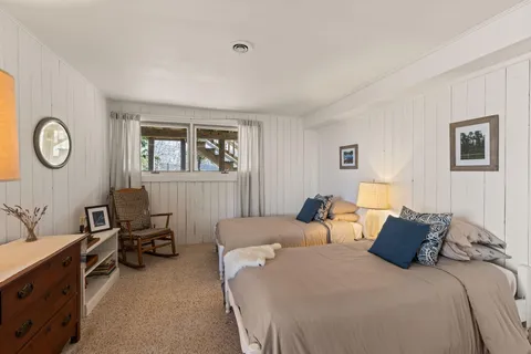 a hotel room with two beds and a chair