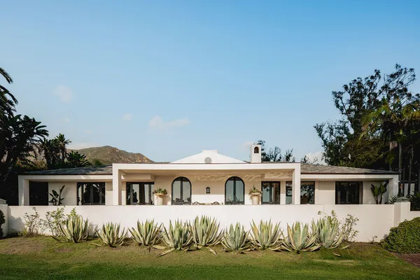 a front view of a house with a garden