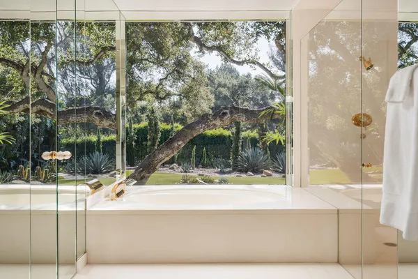 a bedroom with a large bed and a large window