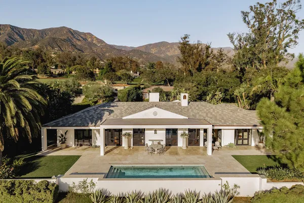 an aerial view of residential houses with outdoor space and river