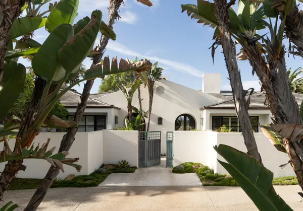a front view of a house with a garden