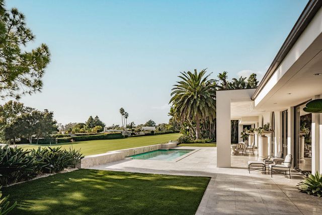 a view of a swimming pool and lounge chairs