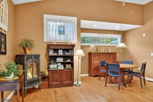 a dining room with furniture and a floor to ceiling window