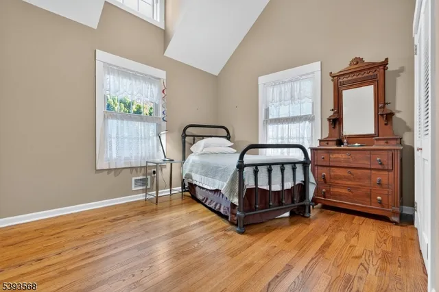 a bedroom with a bed window and a dresser
