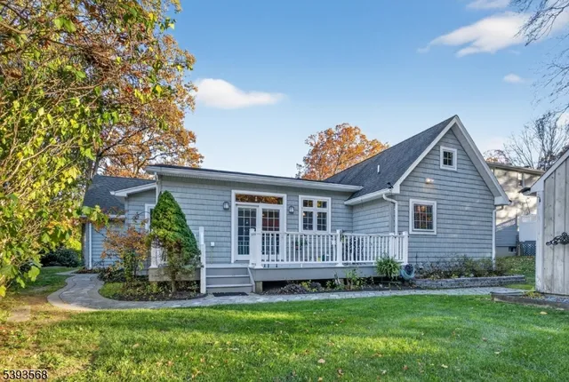 a view of a house with a yard and potted plants