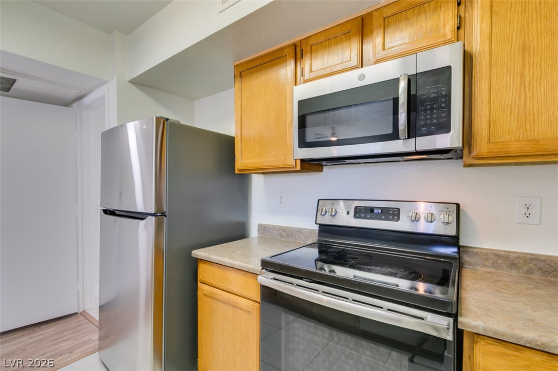 6650 West Warm Springs Road, Unit 2118 Las Vegas, NV 89118 - Photo 2 of 41 Modern kitchen with stainless steel appliances awaits culinary adventures.