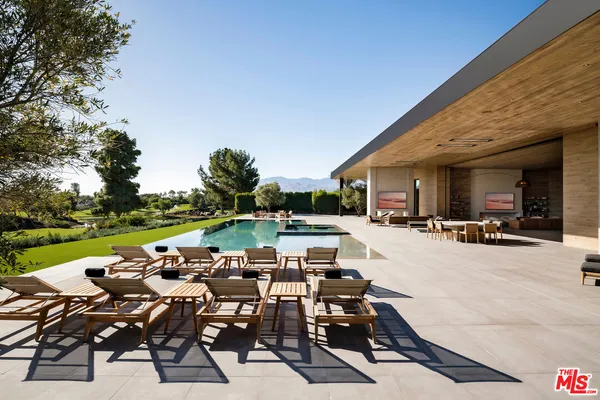 a view of a patio with table and chairs and potted plants