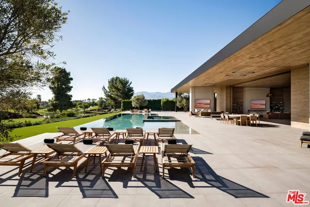 a view of a patio with table and chairs and potted plants