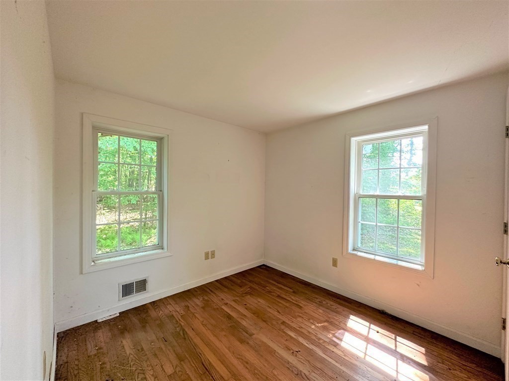 380 Cutler Road Barre, MA 01005 - Photo 11 of 13 an empty room with wooden floor and windows