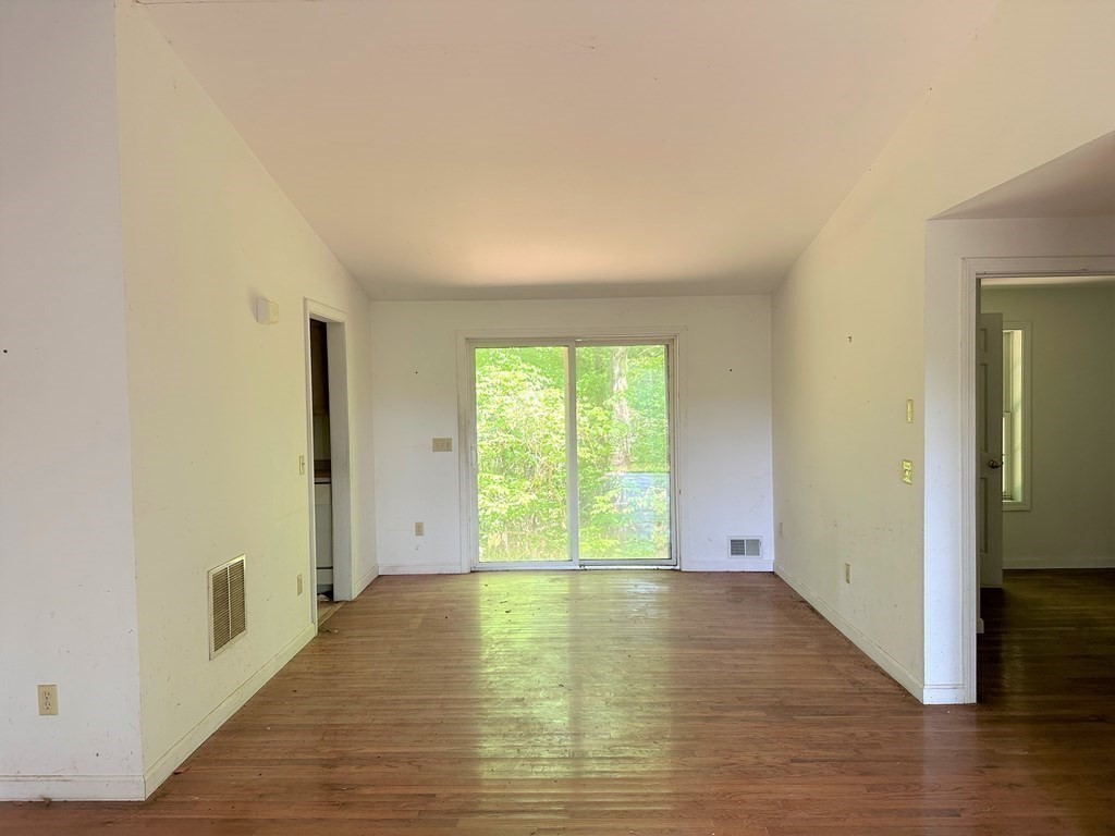 380 Cutler Road Barre, MA 01005 - Photo 4 of 13 a view of empty room with wooden floor and fan