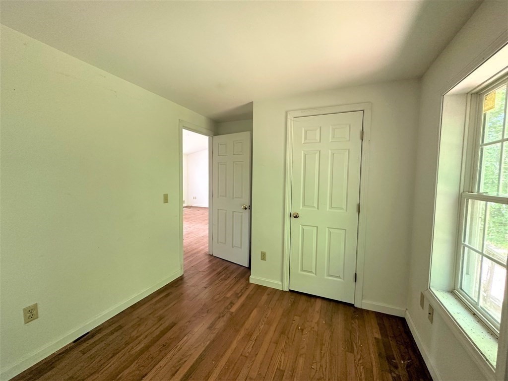 380 Cutler Road Barre, MA 01005 - Photo 9 of 13 an empty room with wooden floor and windows