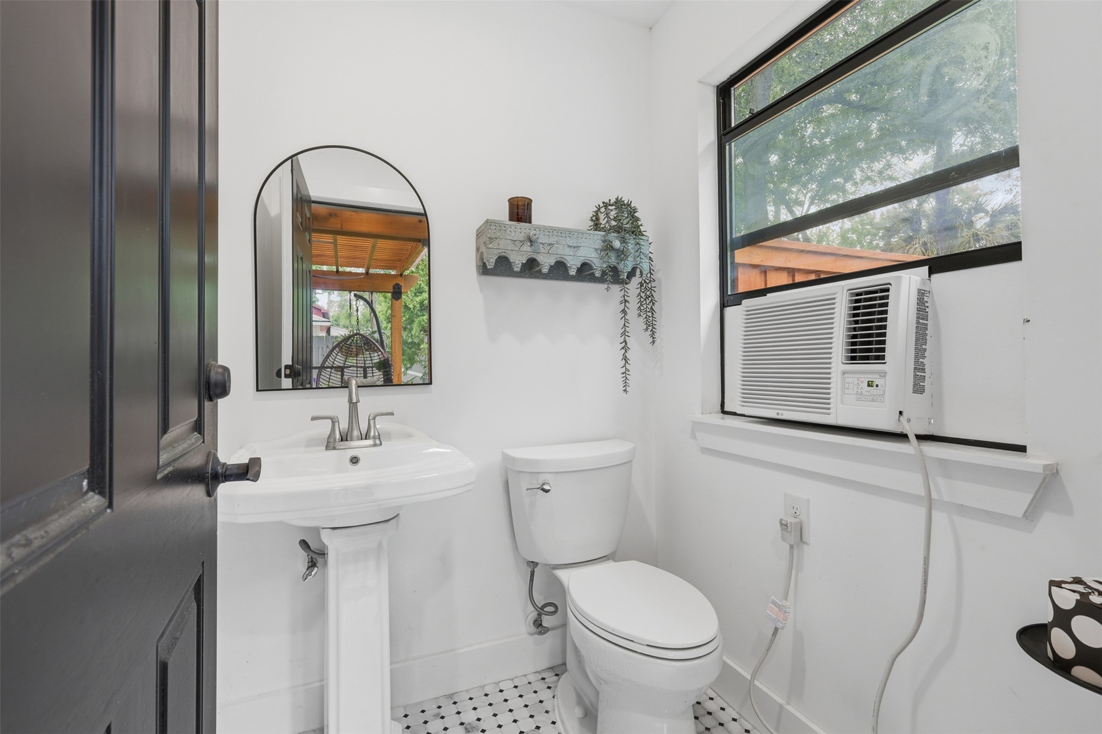 6126 Hickorycrest Drive Spring, TX 77389 - Photo 32 of 50 Half bath with pedestal sink, mirror, and window for natural light.