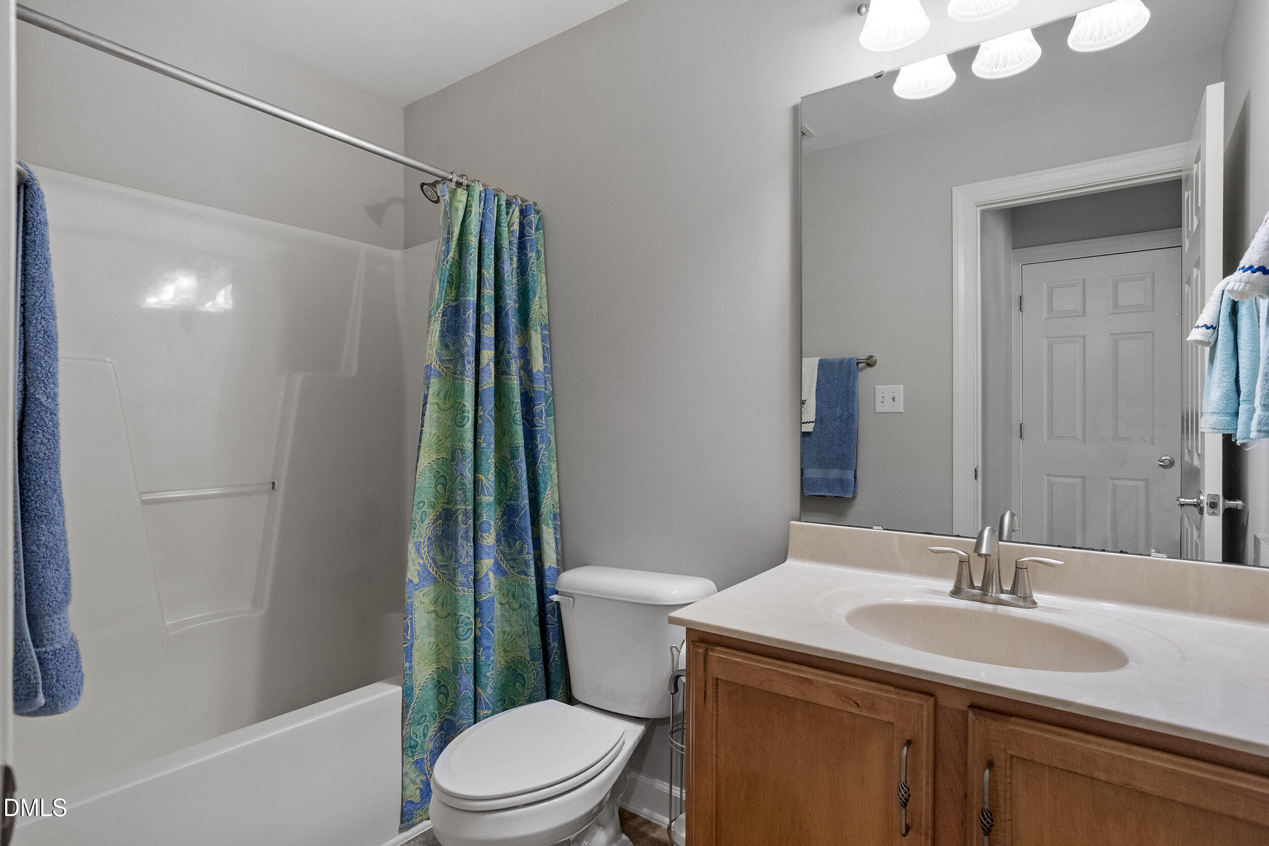 1019 Bianco Drive Raleigh, NC 27607 - Photo 19 of 29 a bathroom with a sink a toilet a mirror and shower