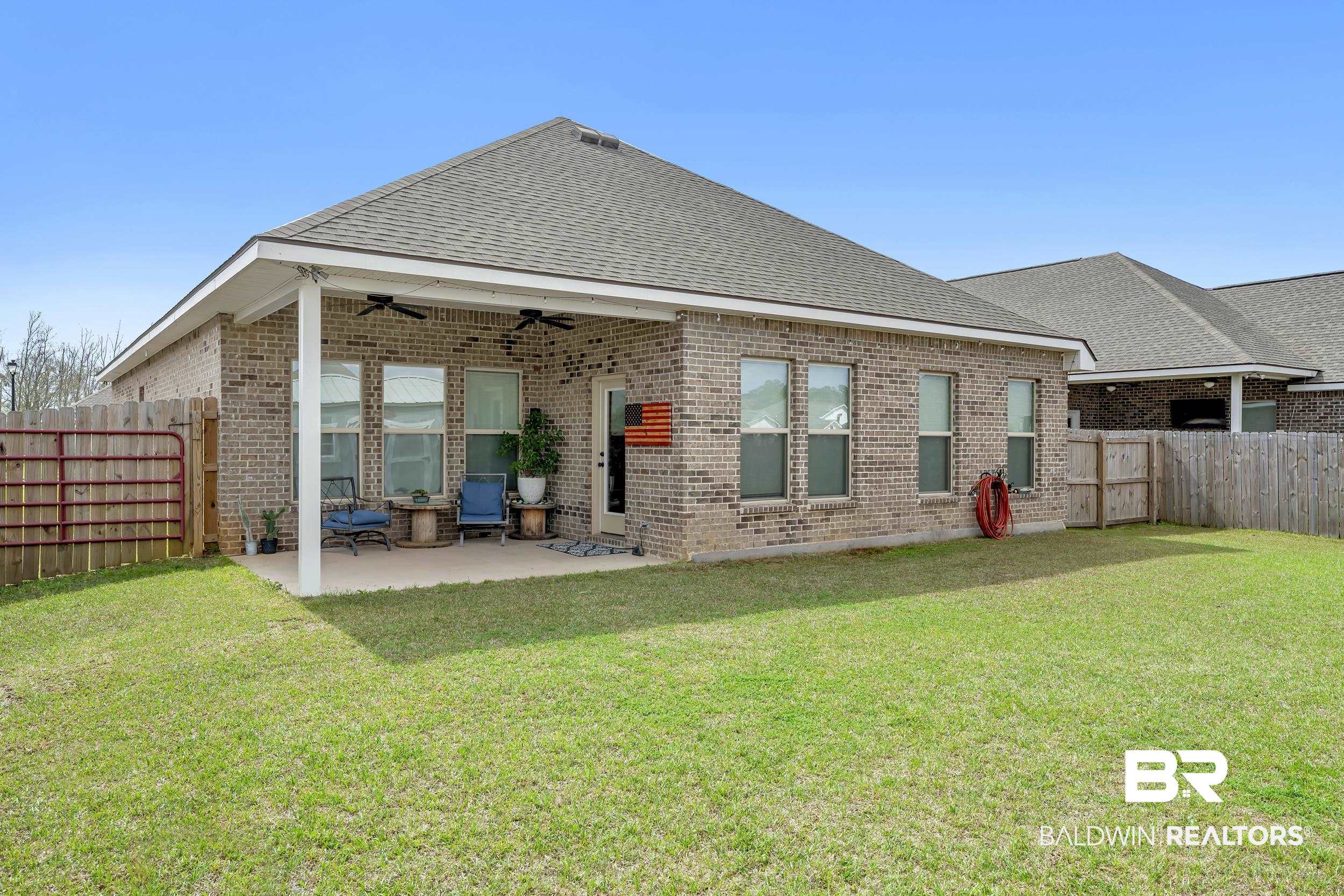 1176 Stella Road Foley, AL 36535 - Photo 31 of 40 Back of house with a fenced backyard, a ceiling fan, a patio area, and brick siding