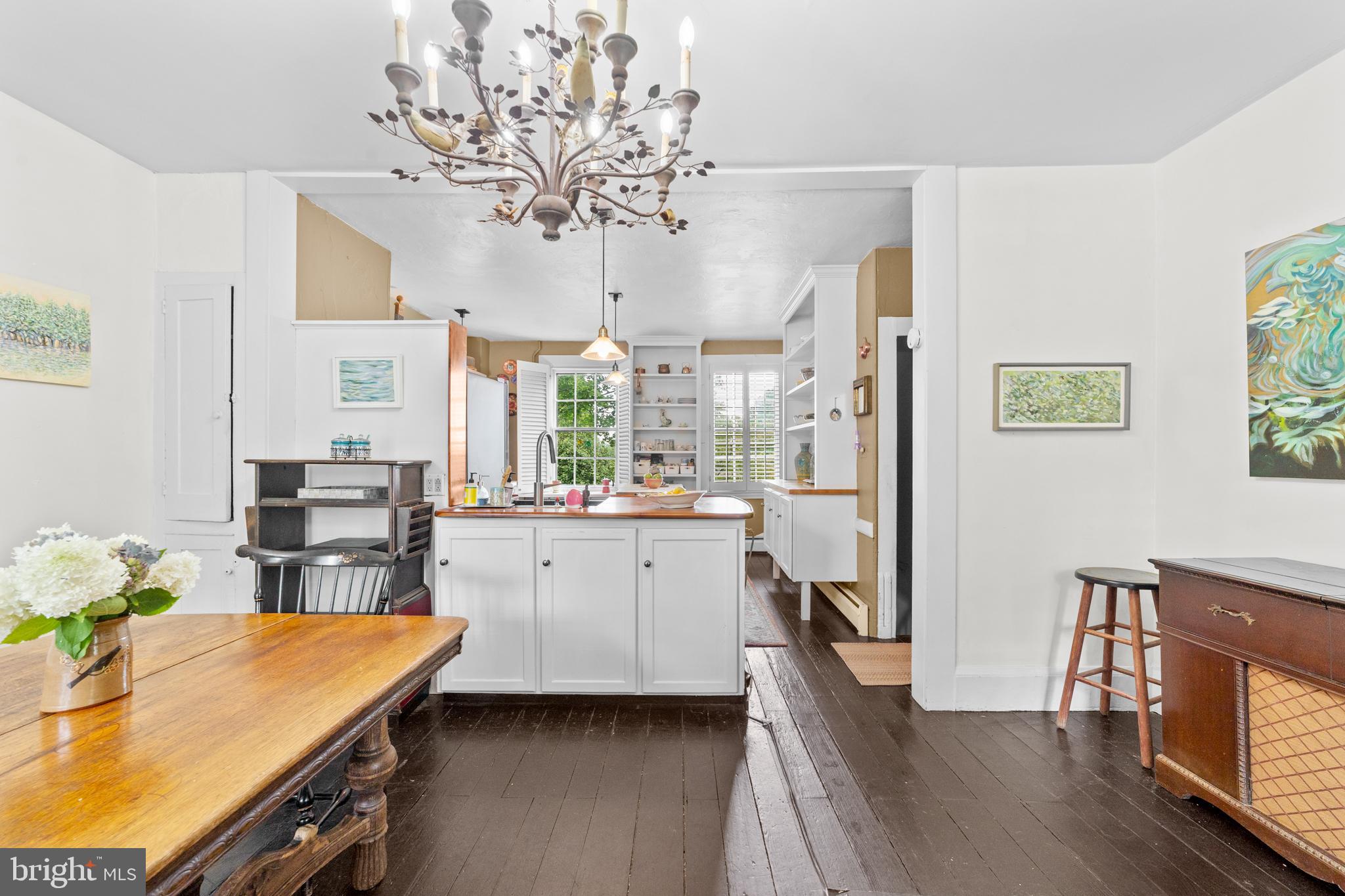 327 East Street Road Kennett Square, PA 19348 - Photo 10 of 43 a kitchen with stainless steel appliances granite countertop a refrigerator a sink dishwasher a stove a dining table and chairs with wooden floor