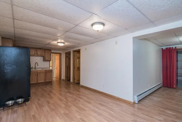 a view of an empty room with a kitchen