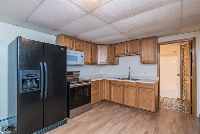 a kitchen with stainless steel appliances granite countertop a refrigerator and a sink