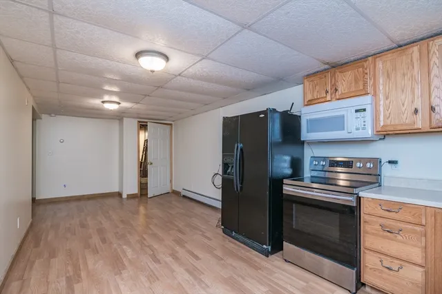 a kitchen with stainless steel appliances granite countertop a refrigerator and a stove top oven