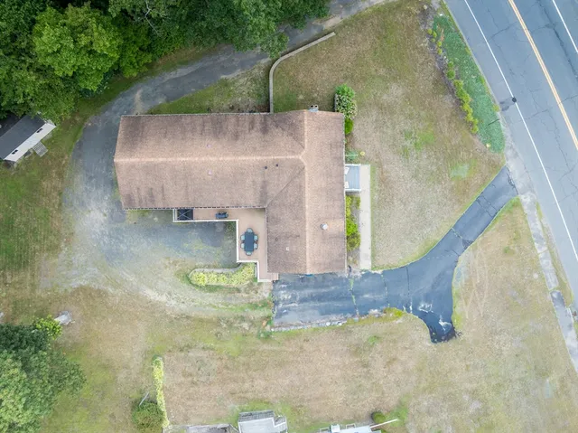 a view of a house with backyard and sitting area