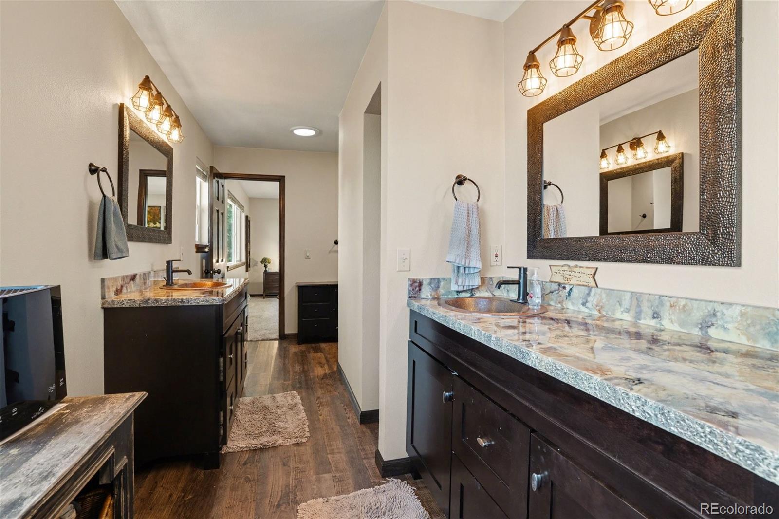 6224 Powell Road Parker, CO 80134 - Photo 14 of 40 a bathroom with a granite countertop double vanity sink and a mirror