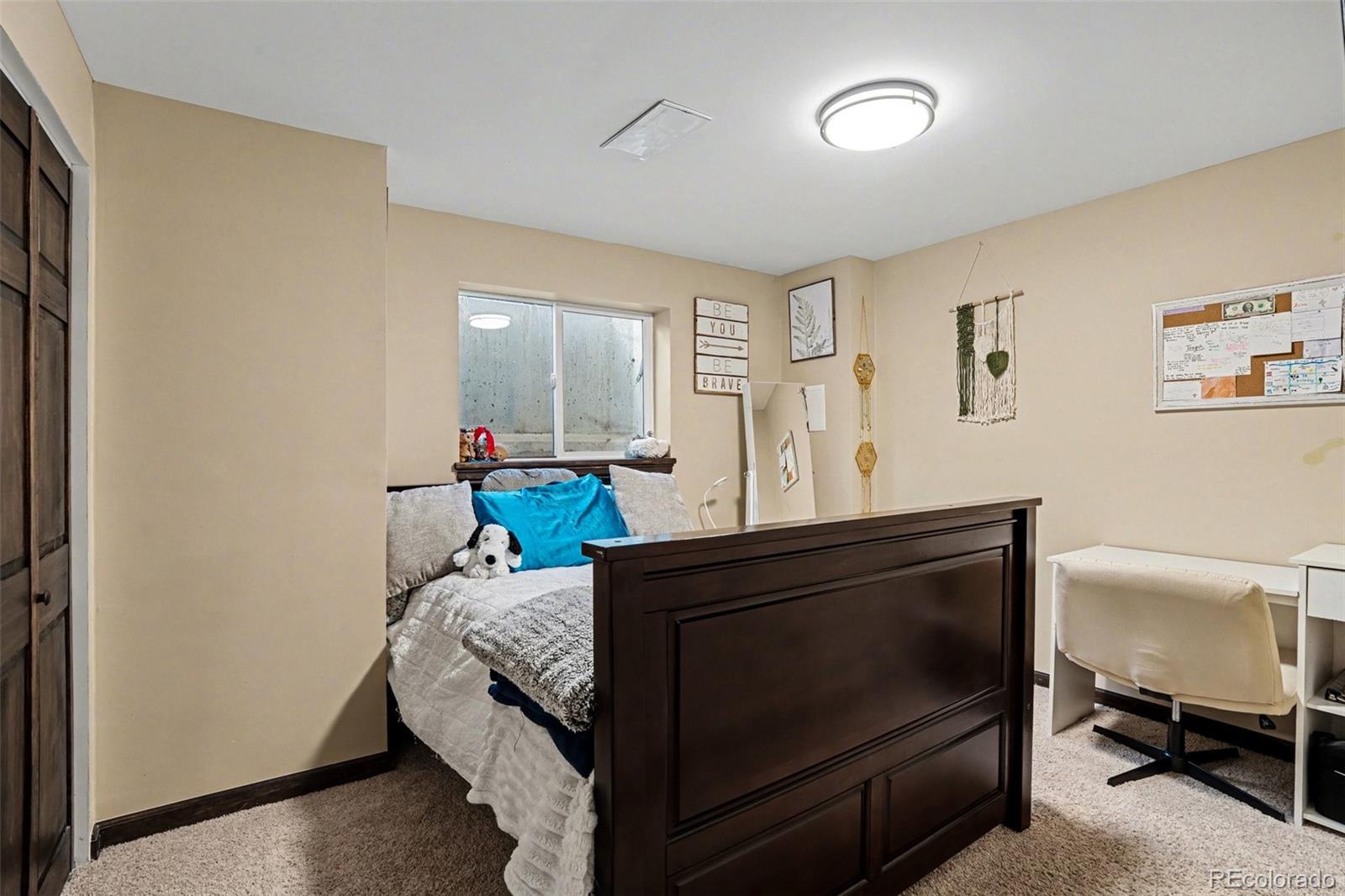 6224 Powell Road Parker, CO 80134 - Photo 23 of 40 a bed sitting in a room next to a window with pc on the table