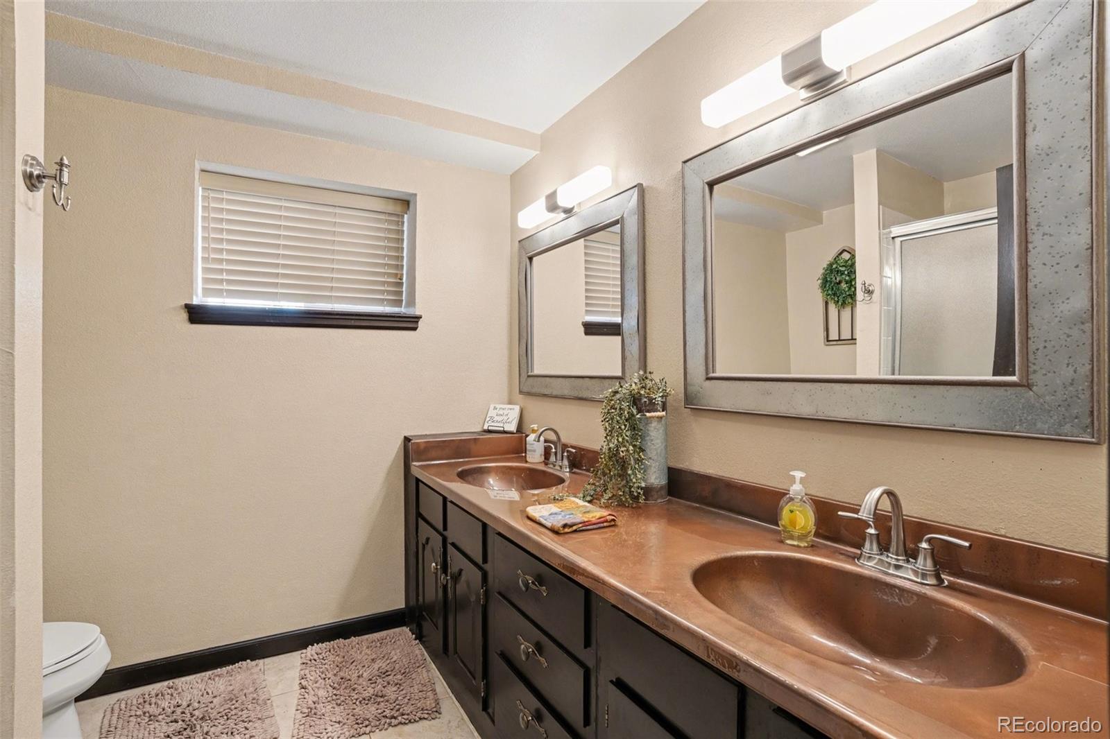 6224 Powell Road Parker, CO 80134 - Photo 25 of 40 a bathroom with a sink and a mirror
