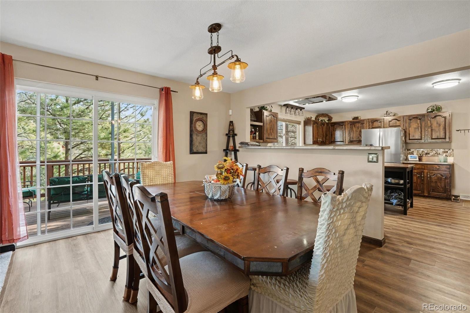 6224 Powell Road Parker, CO 80134 - Photo 5 of 40 a view of a dining room with furniture window and wooden floor