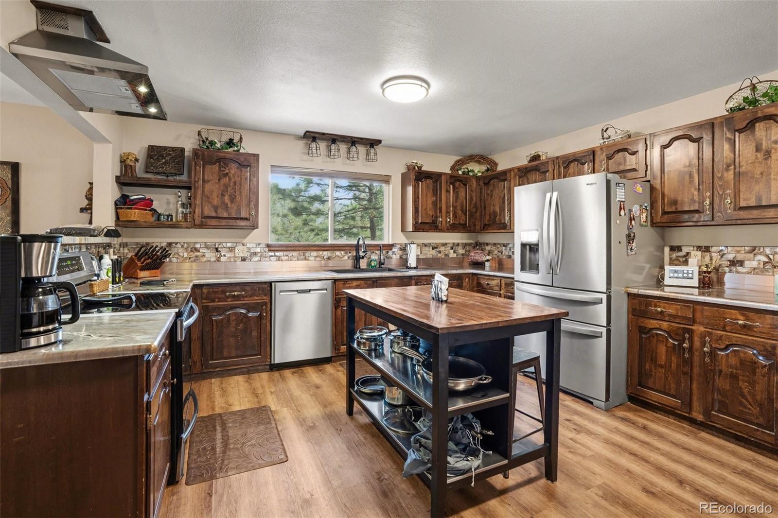 6224 Powell Road Parker, CO 80134 - Photo 7 of 40 a kitchen with stainless steel appliances granite countertop a sink stove and refrigerator