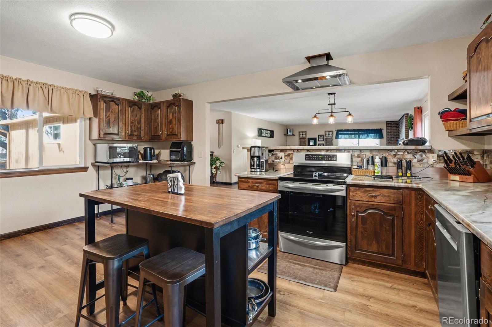 6224 Powell Road Parker, CO 80134 - Photo 9 of 40 a kitchen with stainless steel appliances granite countertop a sink stove and refrigerator